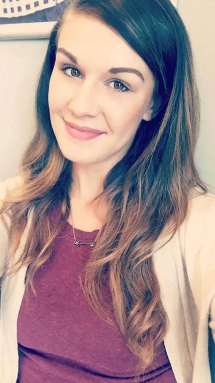 Abby Lynn Patterson smiling in a portrait photo