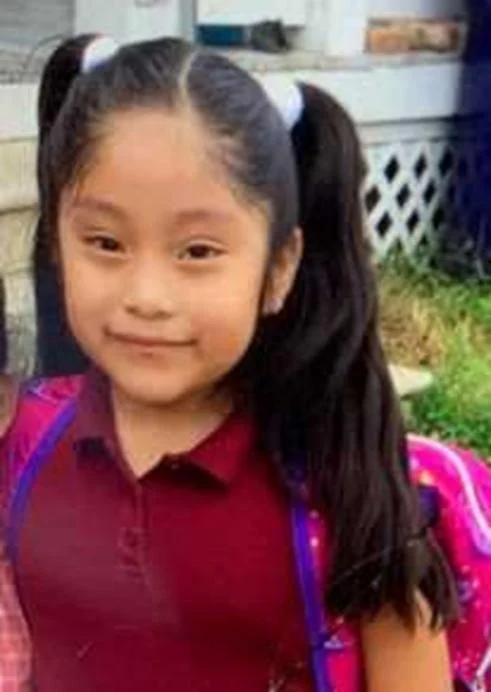 Dulce Maria Alavez as a young child in an outdoor photo.